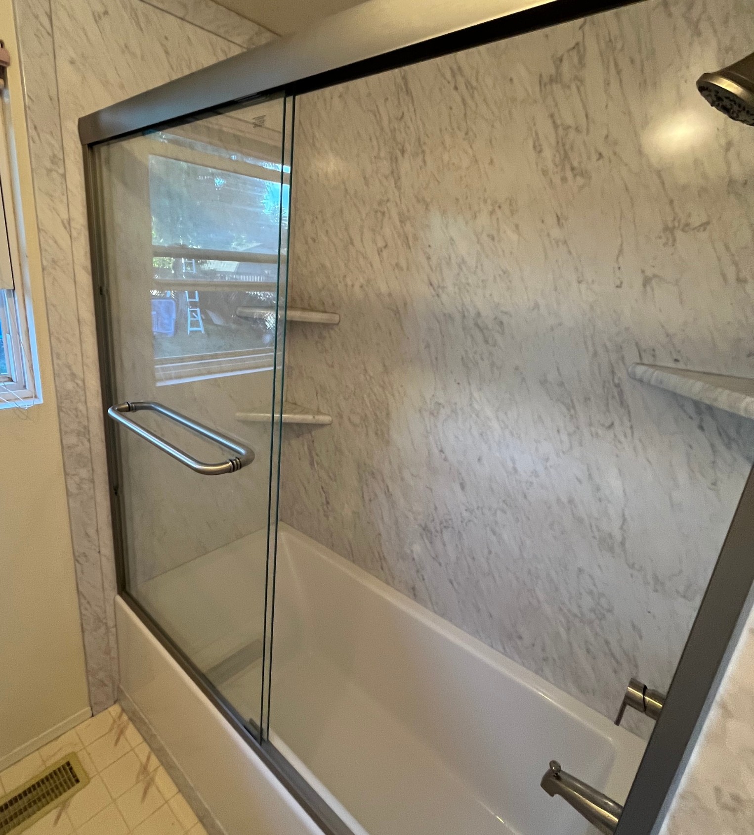 Newly remodeled shower with chrome fixtures and waterproof walls