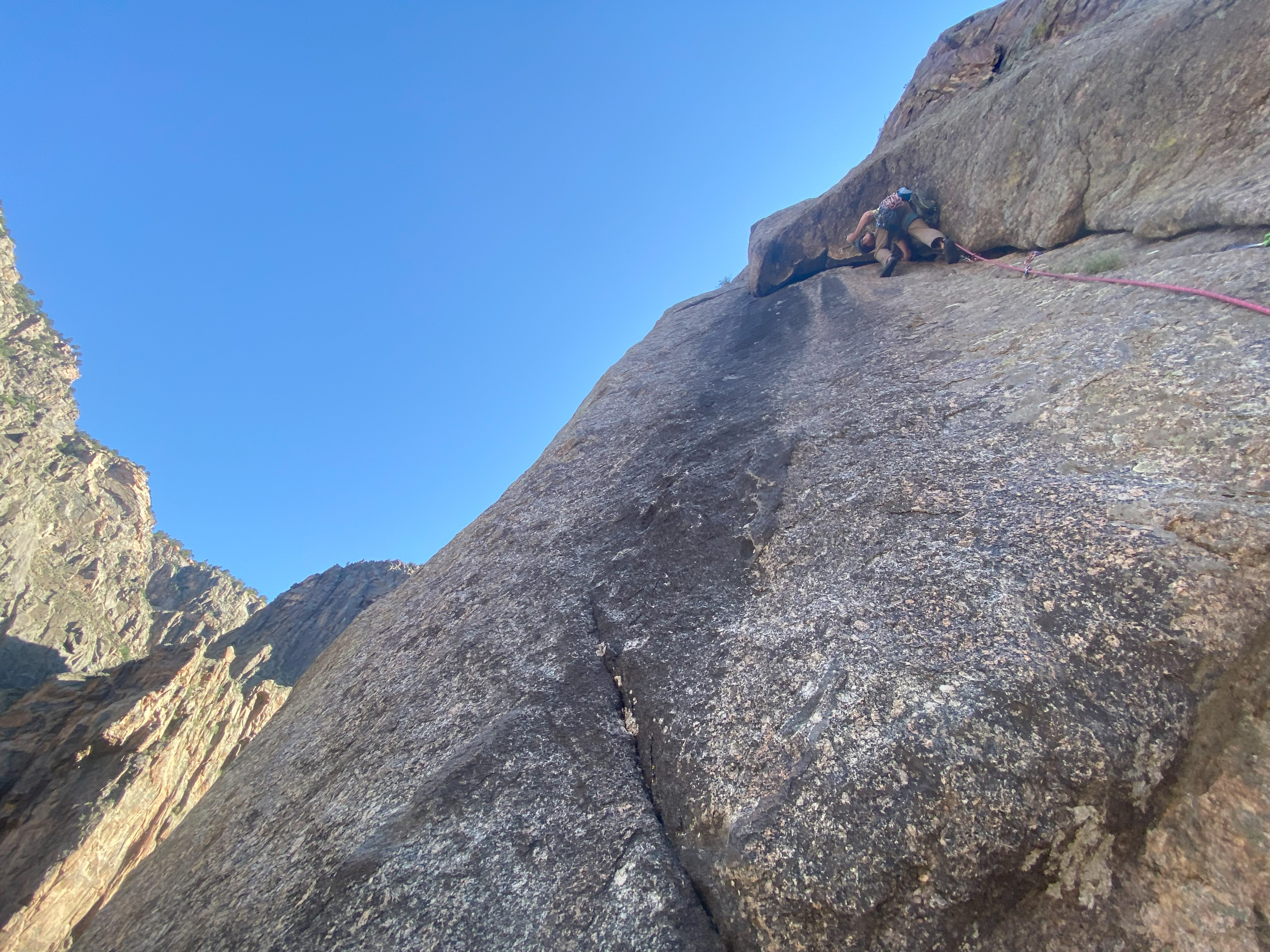 Climber places cam in rising crack in Black Canyon