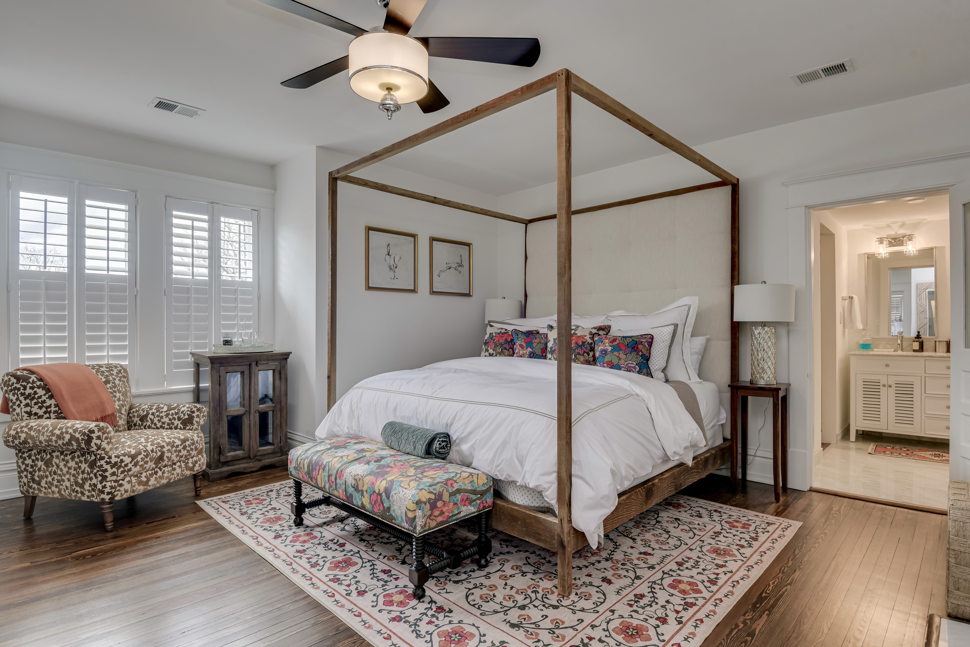 A spacious suite boasting a regal four-poster king bed, a queen bed, and a large trundle in the private living area.