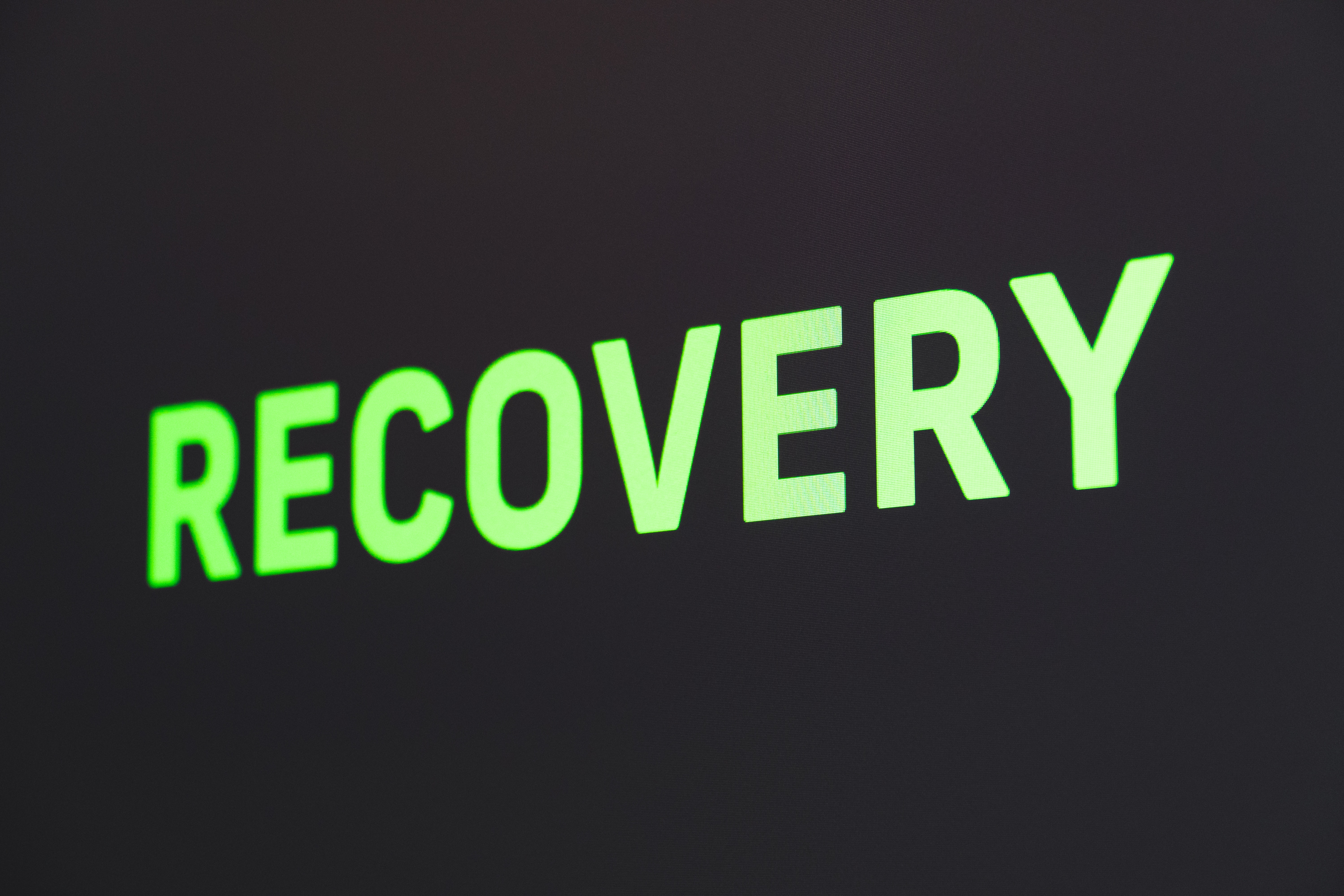 The word "recovery" in green on a black background