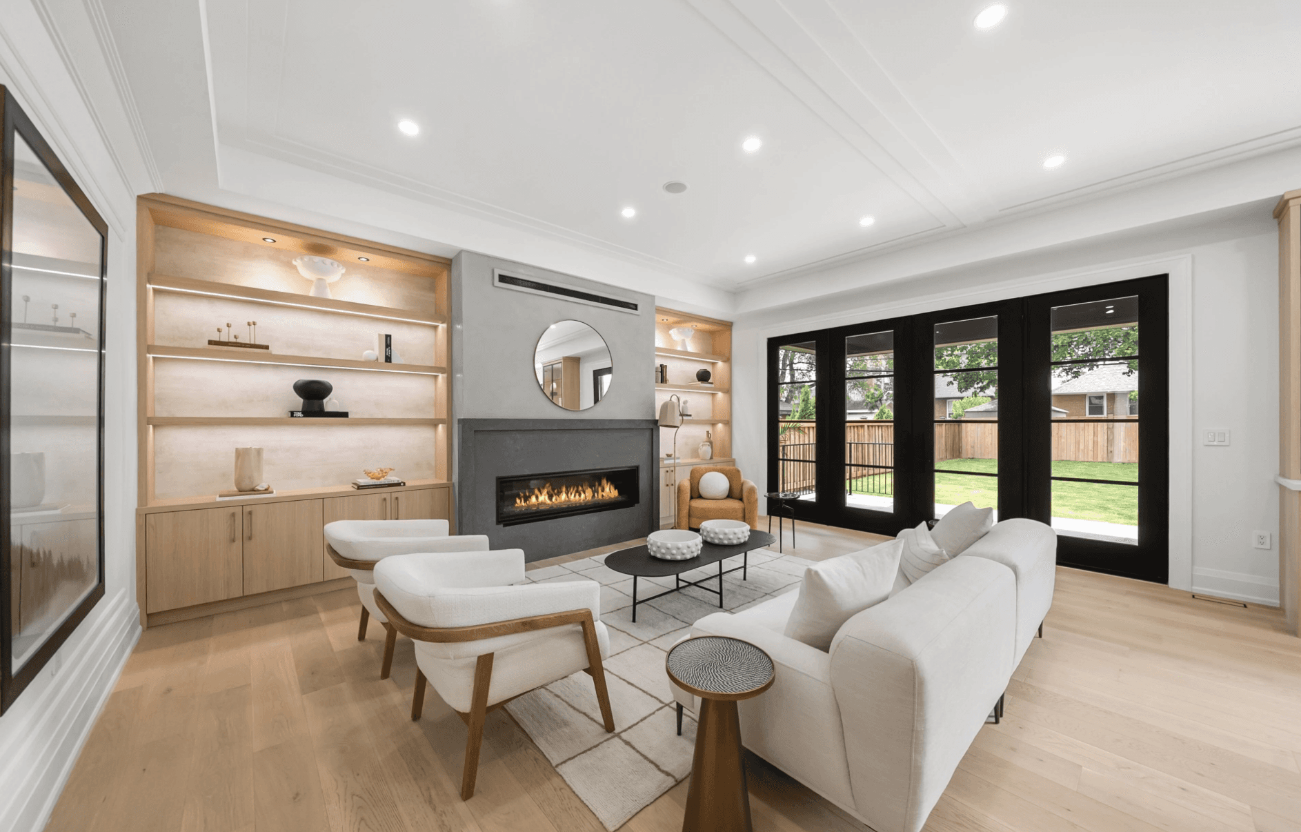 Spacious, luxurious living room with high ceilings, an elegant beige sectional sofa, warm ambient lighting, classical artwork, and rustic architectural elements, featuring an open layout with a view of a mezzanine level.