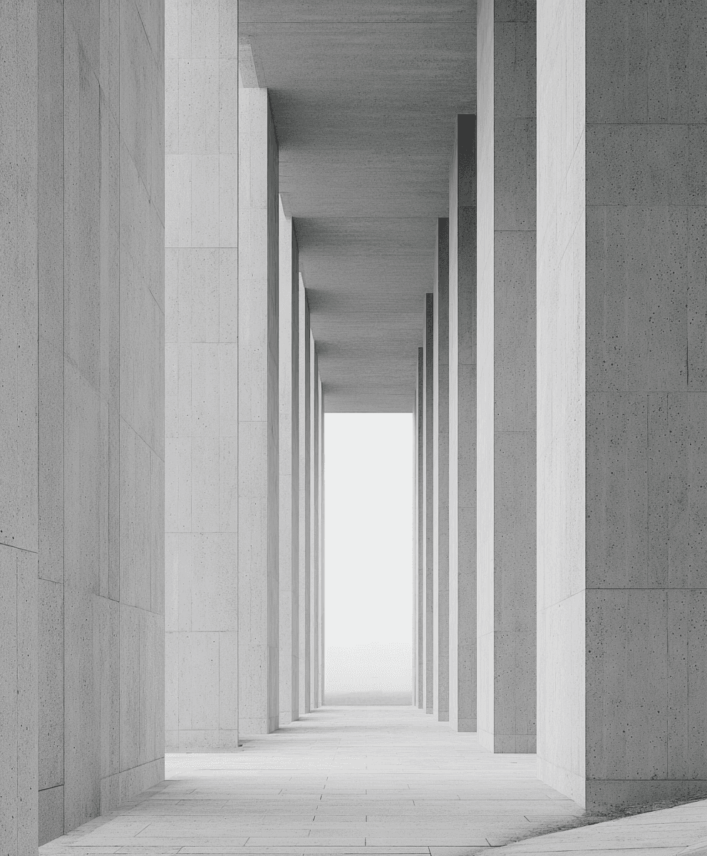 A long corridor of tall concrete columns stretches forward in perfect symmetry, leading the eye toward a bright, mist-filled horizon.