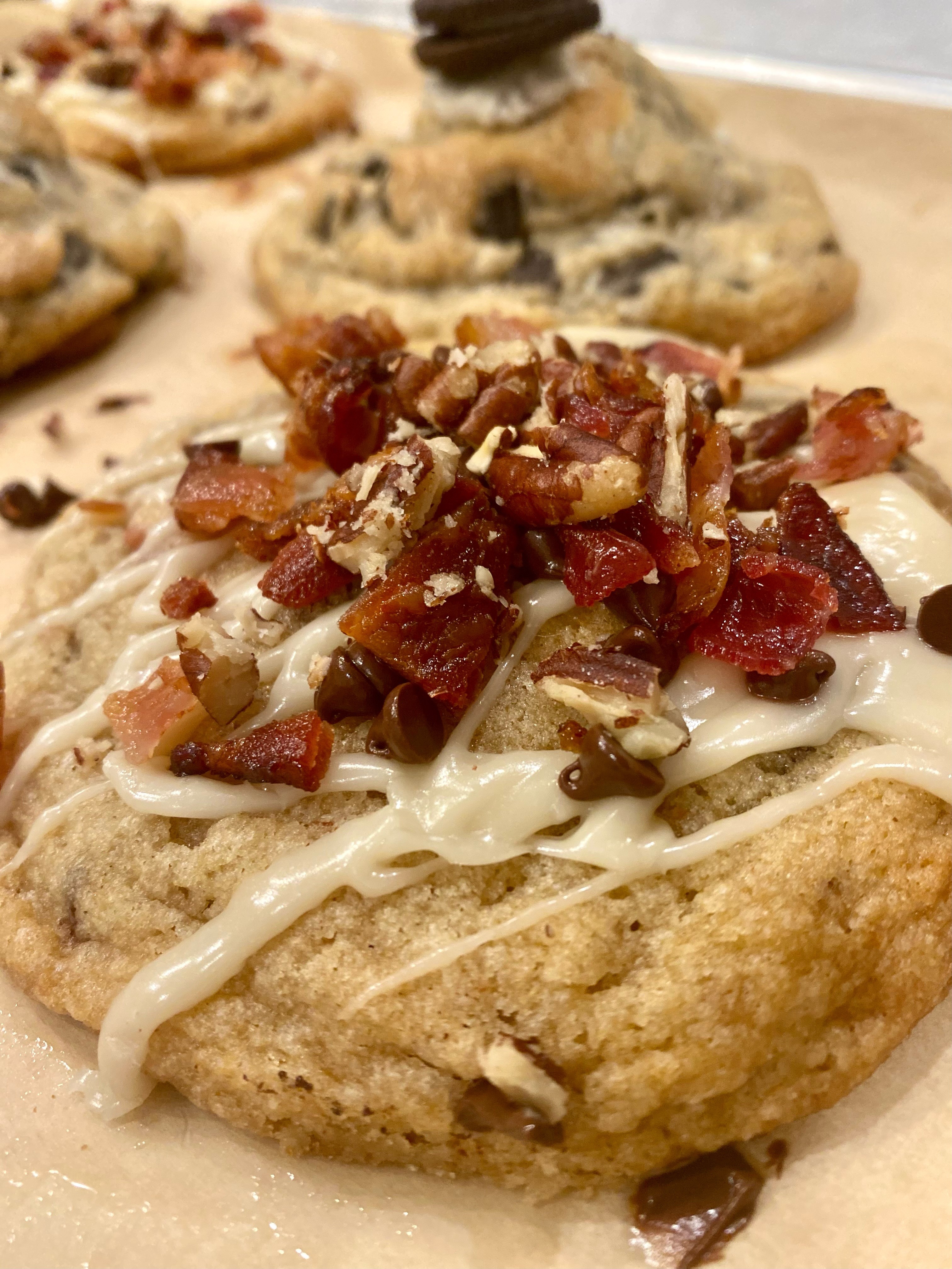 Close-up of bacon, maple, and pecan Levain-style cookies made by hand in Longmont CO