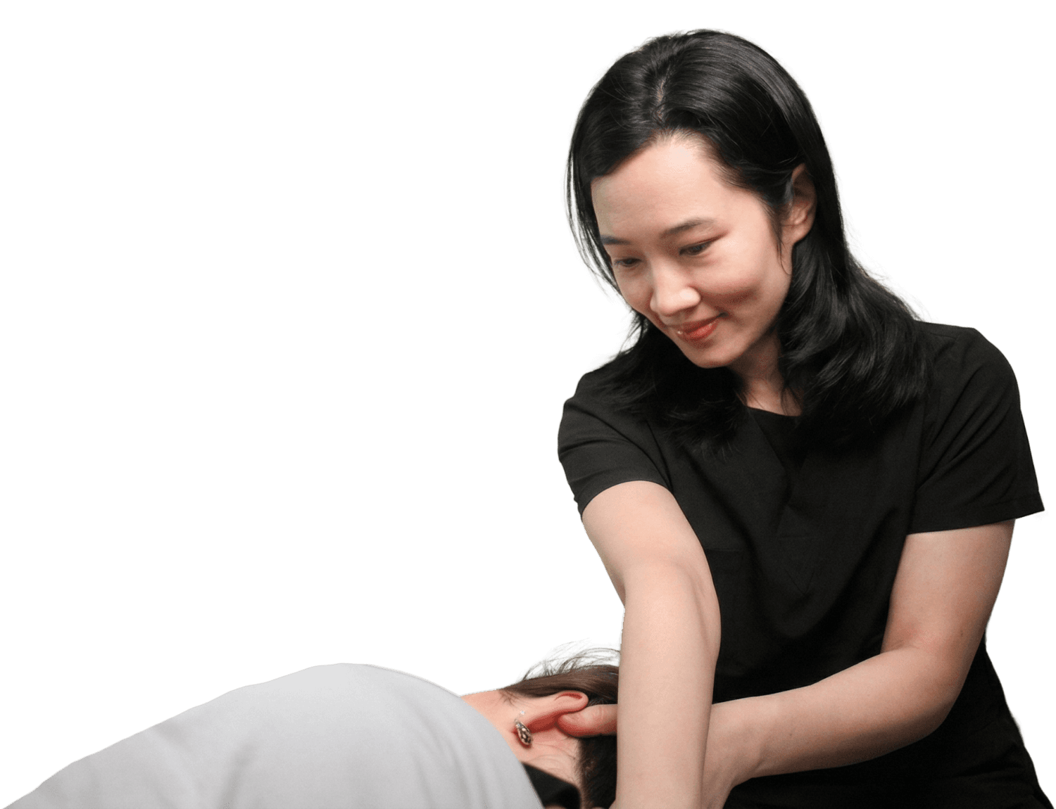 Massage practitioner performing a manual technique on a patient