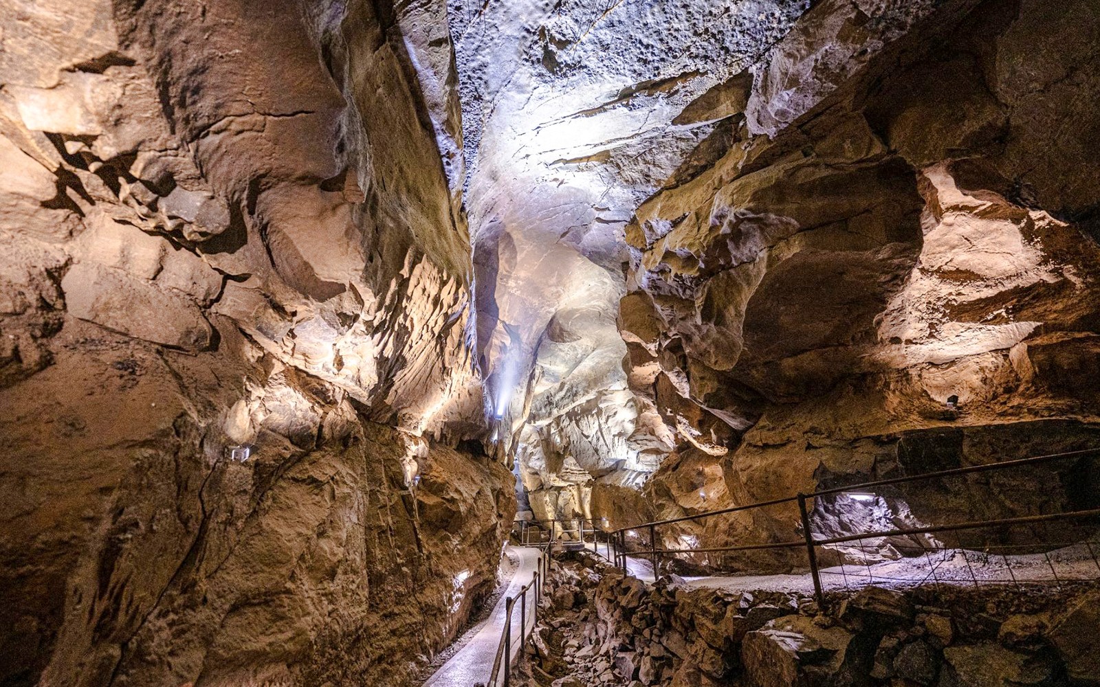 Aillwee Caves passageway with illuminated rock formations in County Clare, Ireland.