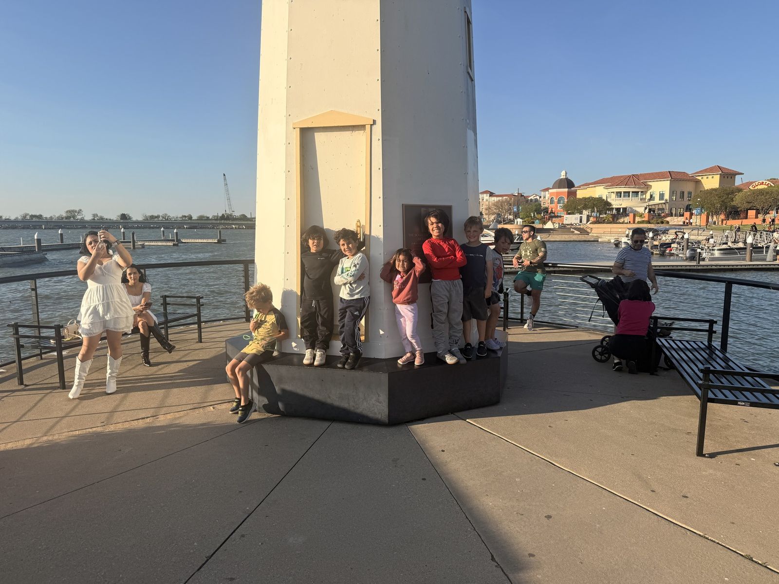 Kids at the lighthouse on the pier at the Harbor in Rockwall, Texas