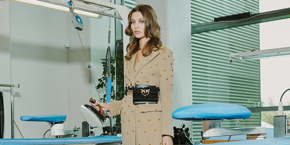 PINKO flagship store interior showcasing premium retail environment with distinctive pink branding and modern architectural design representing brand's physical presence across international markets - omnichannel brand experience and drive-to-store strategy coordination by Alessandro Brancati Marketing & Growth Studio