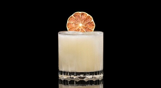 A closeup of a Bananarama drink against a dark background.