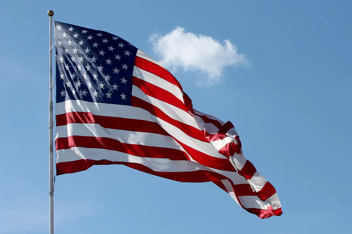 American flag waving in the wind against a clear blue sky