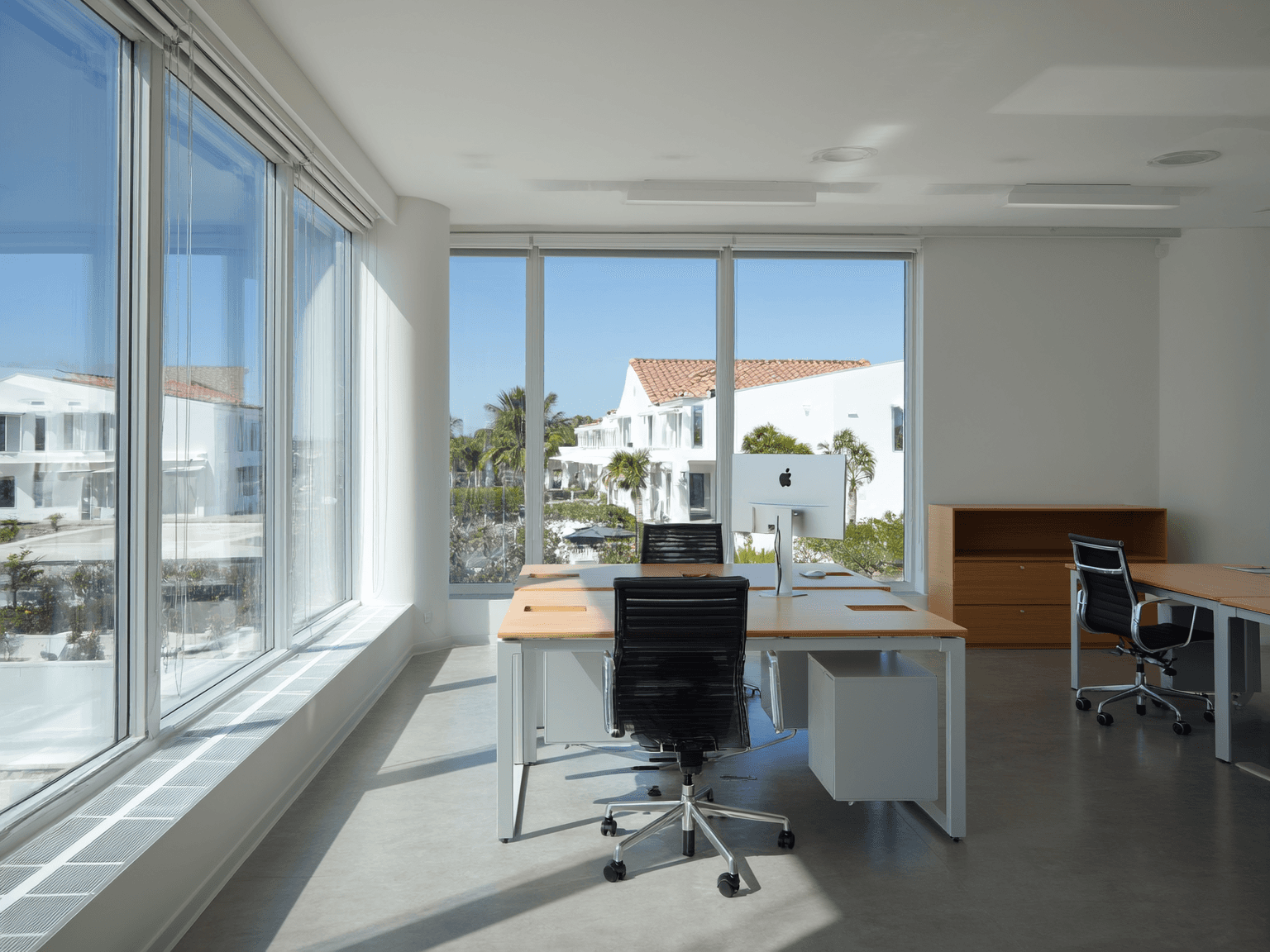 Clean Florida office with large glass windows and organized desks.