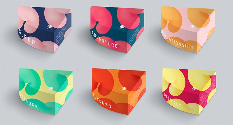 A set of six boxes, each looking like a quarter of a cylinder, a Styrofoam piece design on them and each having different pairs pf colors: blue and pink, blue and red, pink and orange, yellow and green, orange and red, red and yellow.