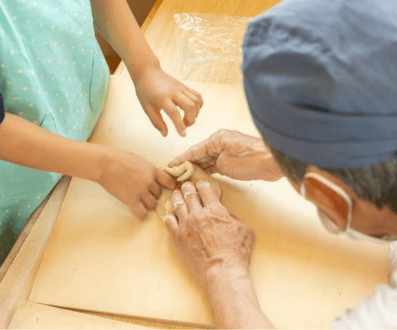 Swordsmiths hammering iron in a team