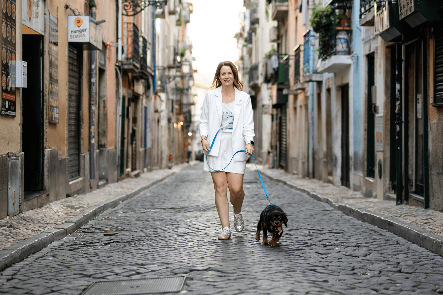Lauren and Peru walking through the streets of Lisbon