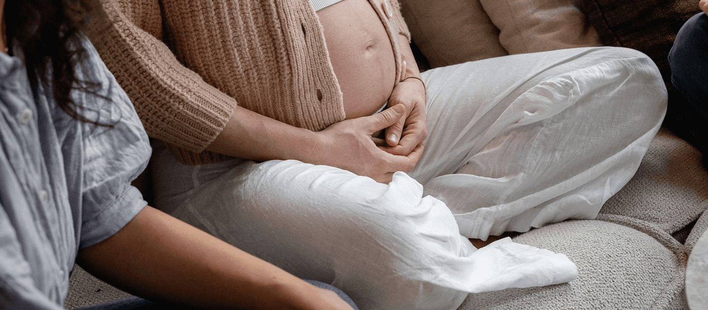 A doula sitting next to her client