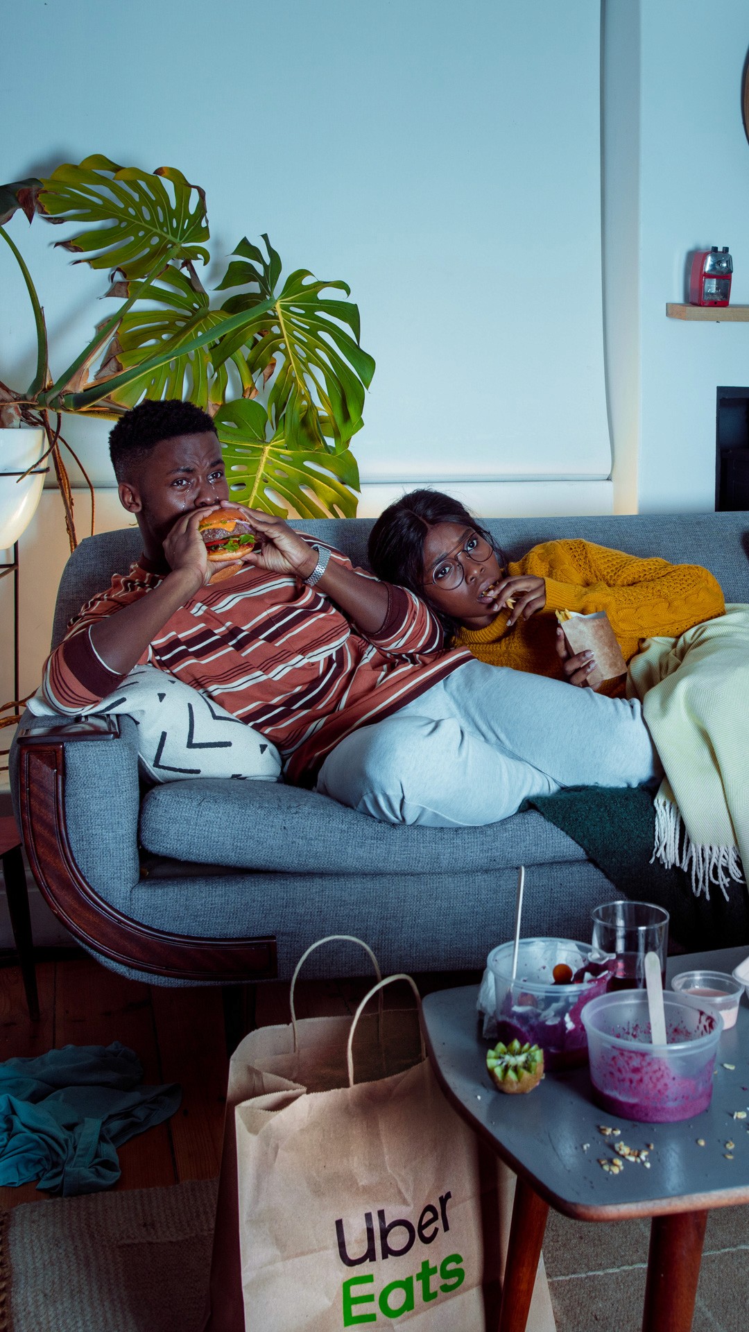 couple eating food and watching a movie