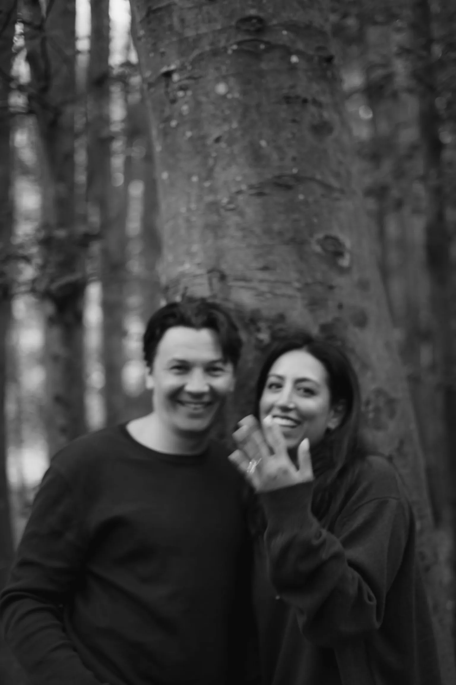 Connor and Cherine in a black-and-white woodland portrait