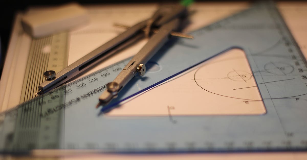 Precision drafting tools including compass and set square on a sketchpad.