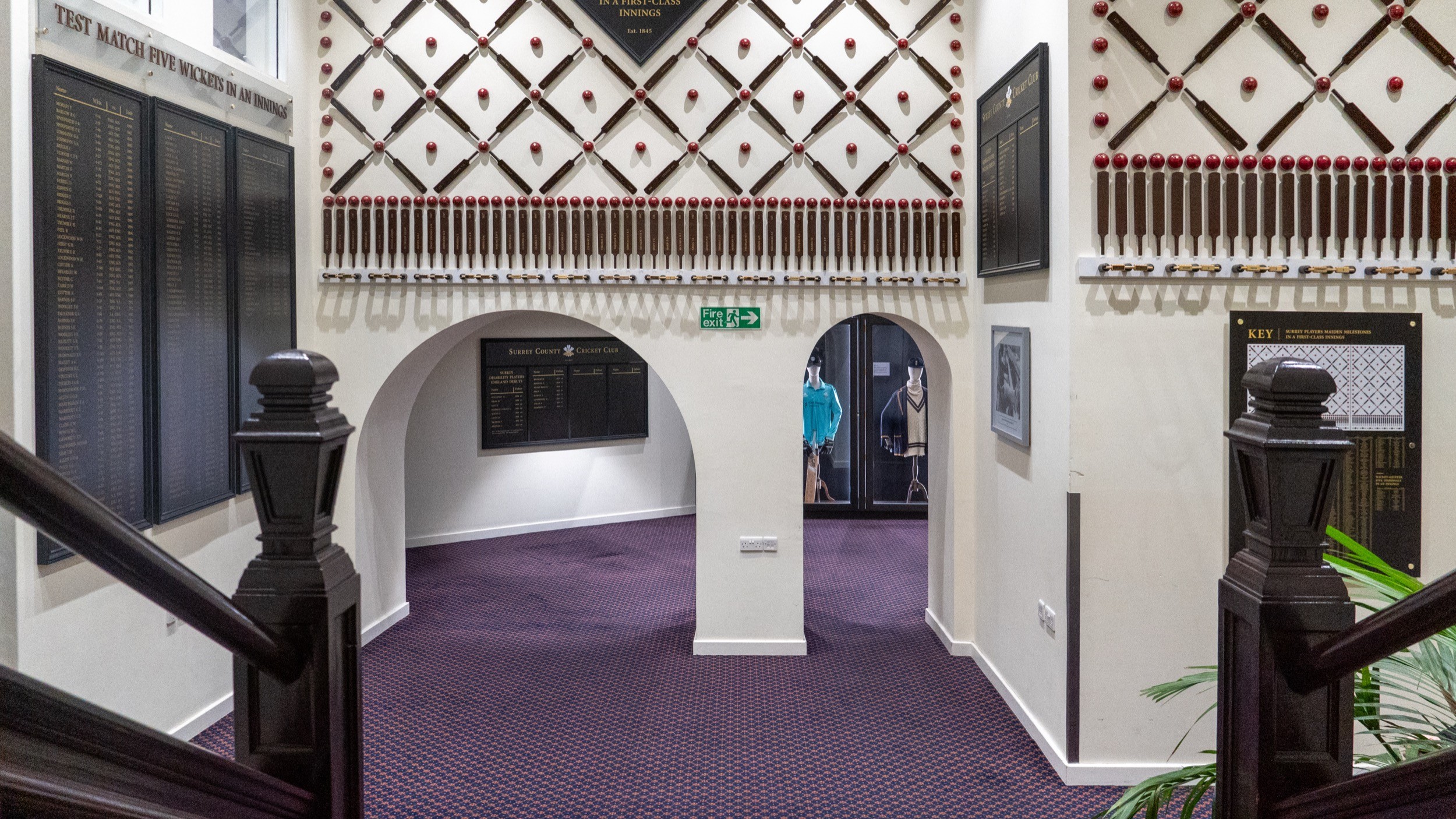 Two classic volkswagen beetles, one green, one cream.