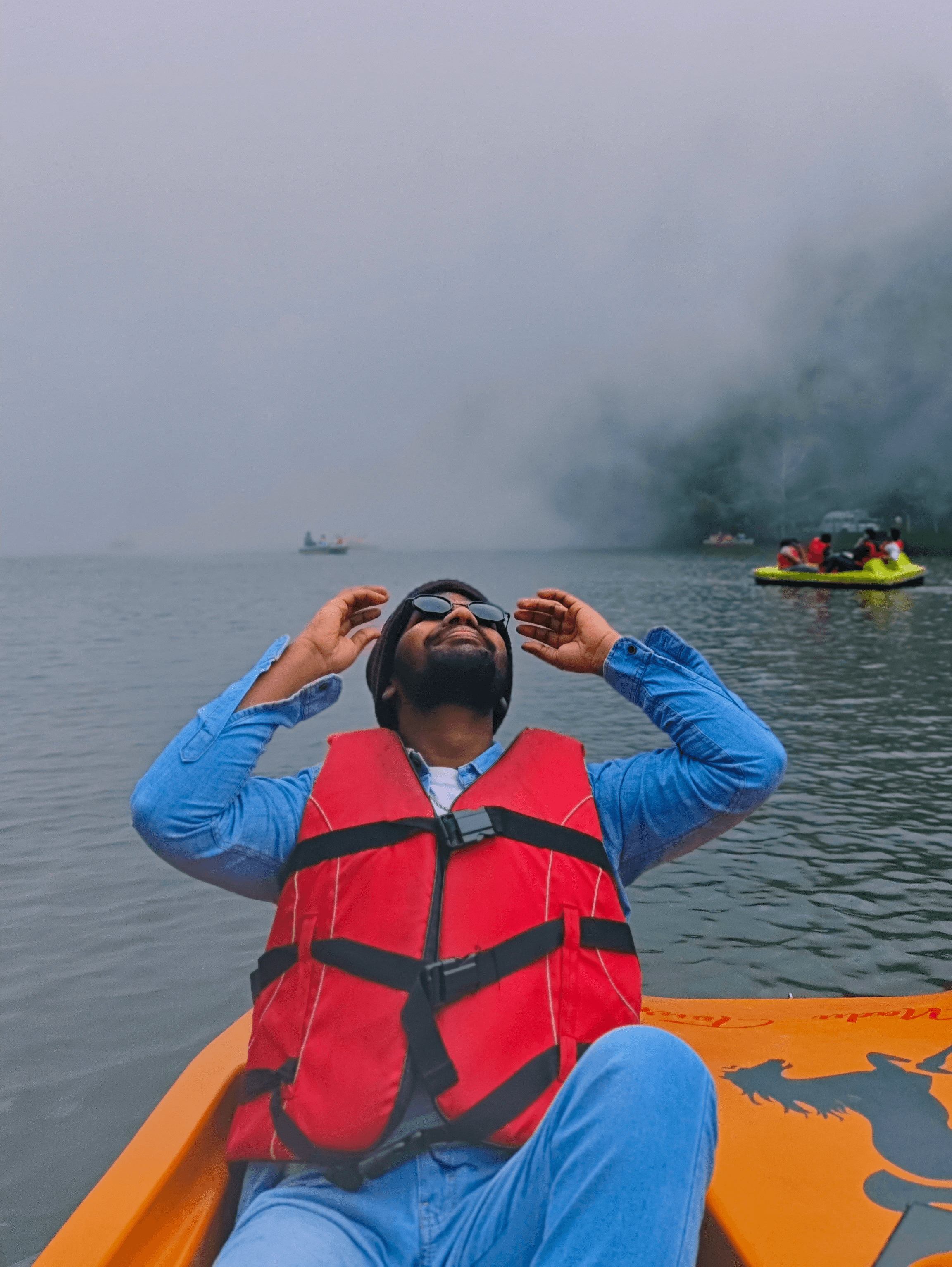 People playing soccer on a rooftop court surrounded by city buildings