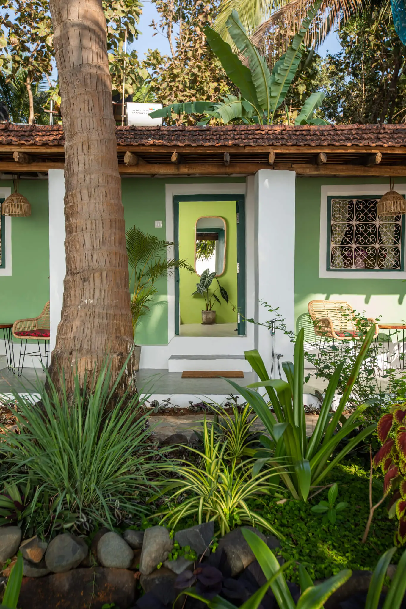 Sea View Family Room at Casa Jaali — cottage entrance behind the palms
