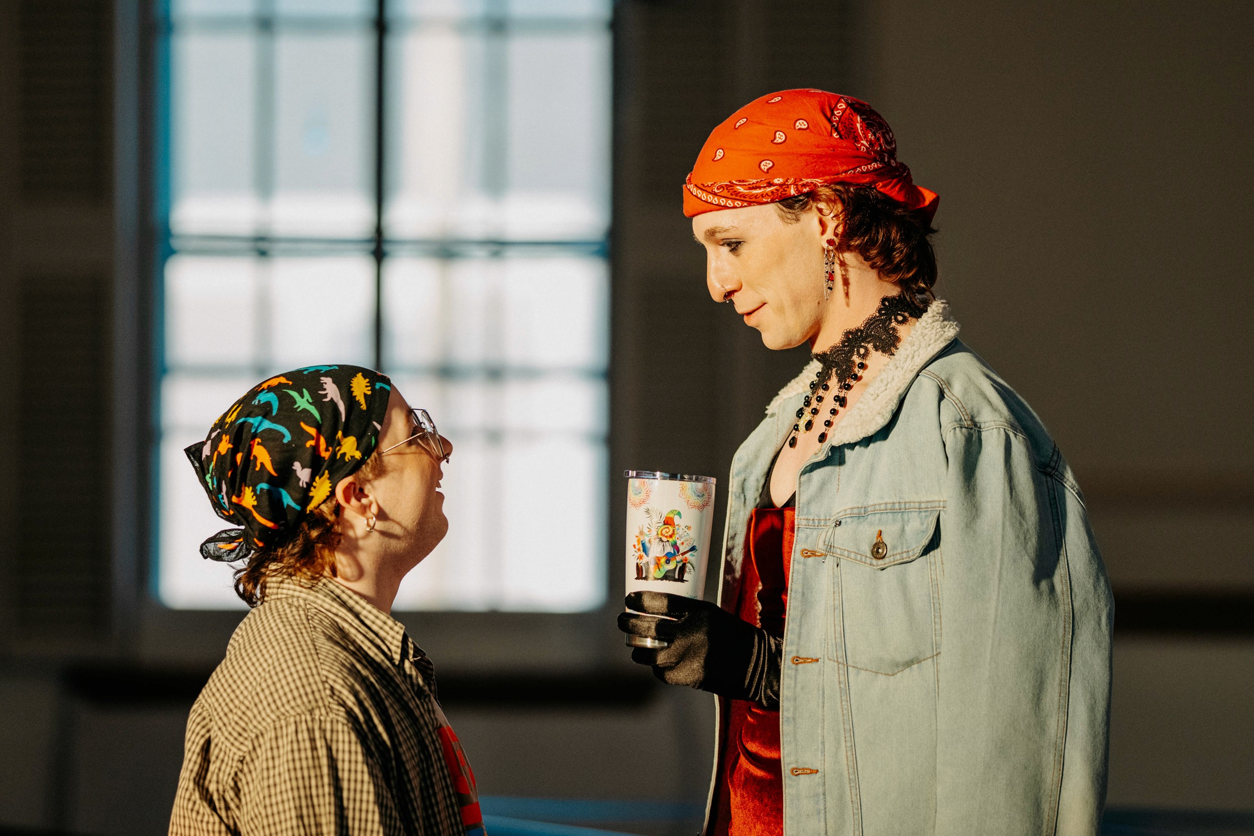 Two performers interacting during a scene at the Queer Open Mic (QOM) hosted by be; community in Bridgewater, Massachusetts