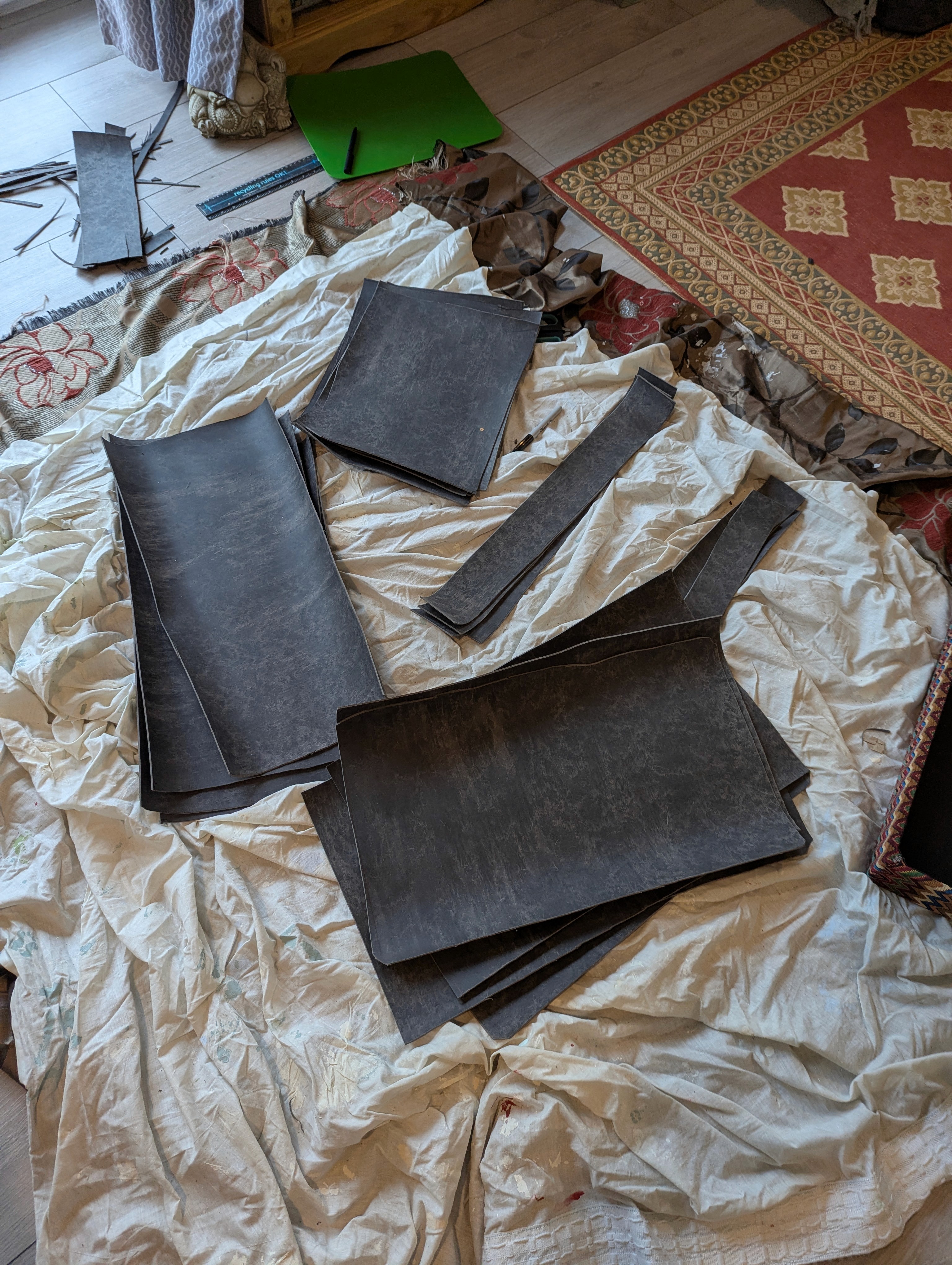 Cut panels of mass-loaded vinyl prepared for lining the inside of the wooden trunk.