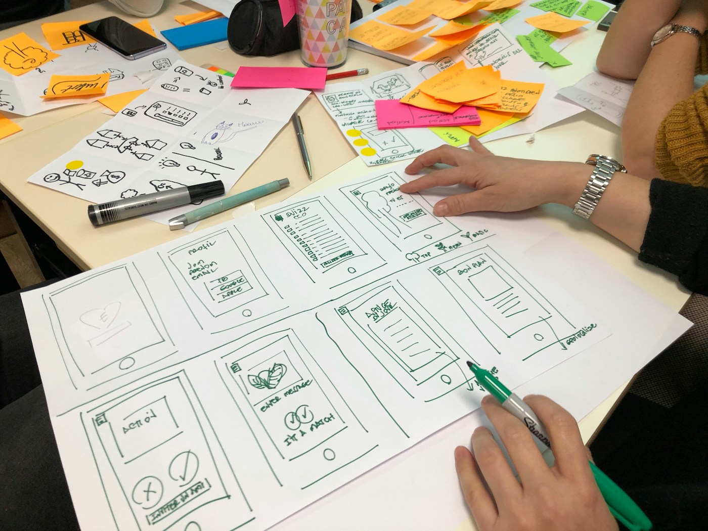 Creative planning notes and printed references on a desk before production approval