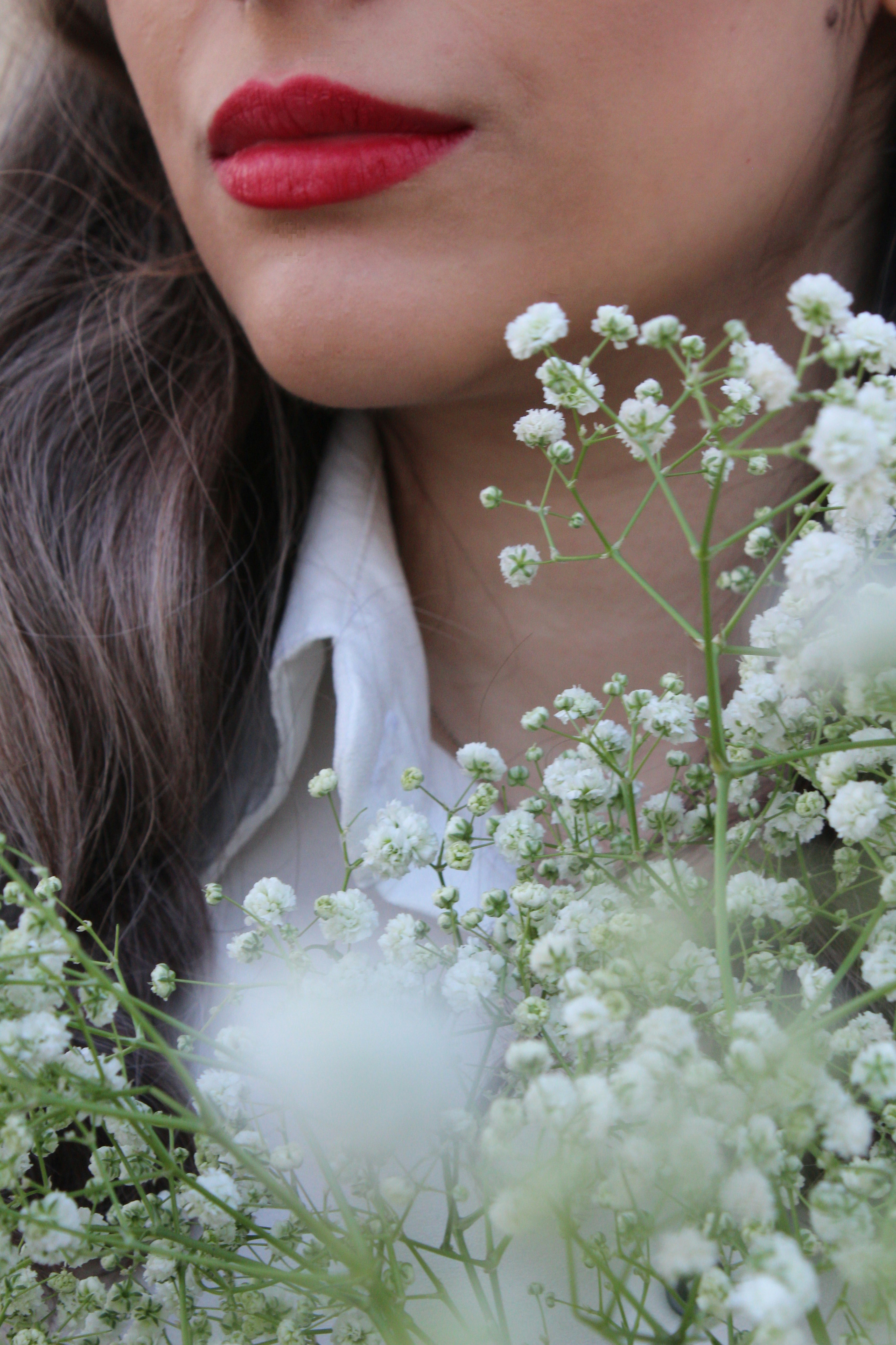 a close up of a person holding flowers