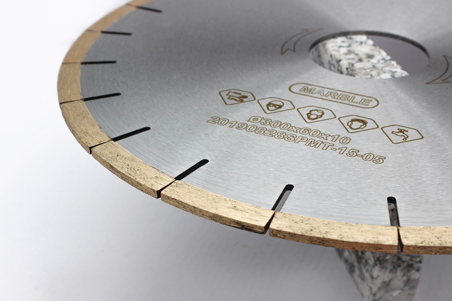 Close-up of the edge of a diamond saw blade, showing the detailed segmentation and diamond grit distribution.