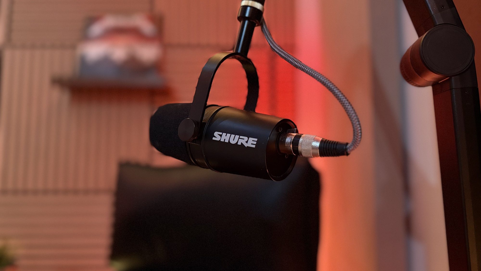 Podcasting equipment setup with high-end microphones and headphones inside a Calgary recording studio control room.