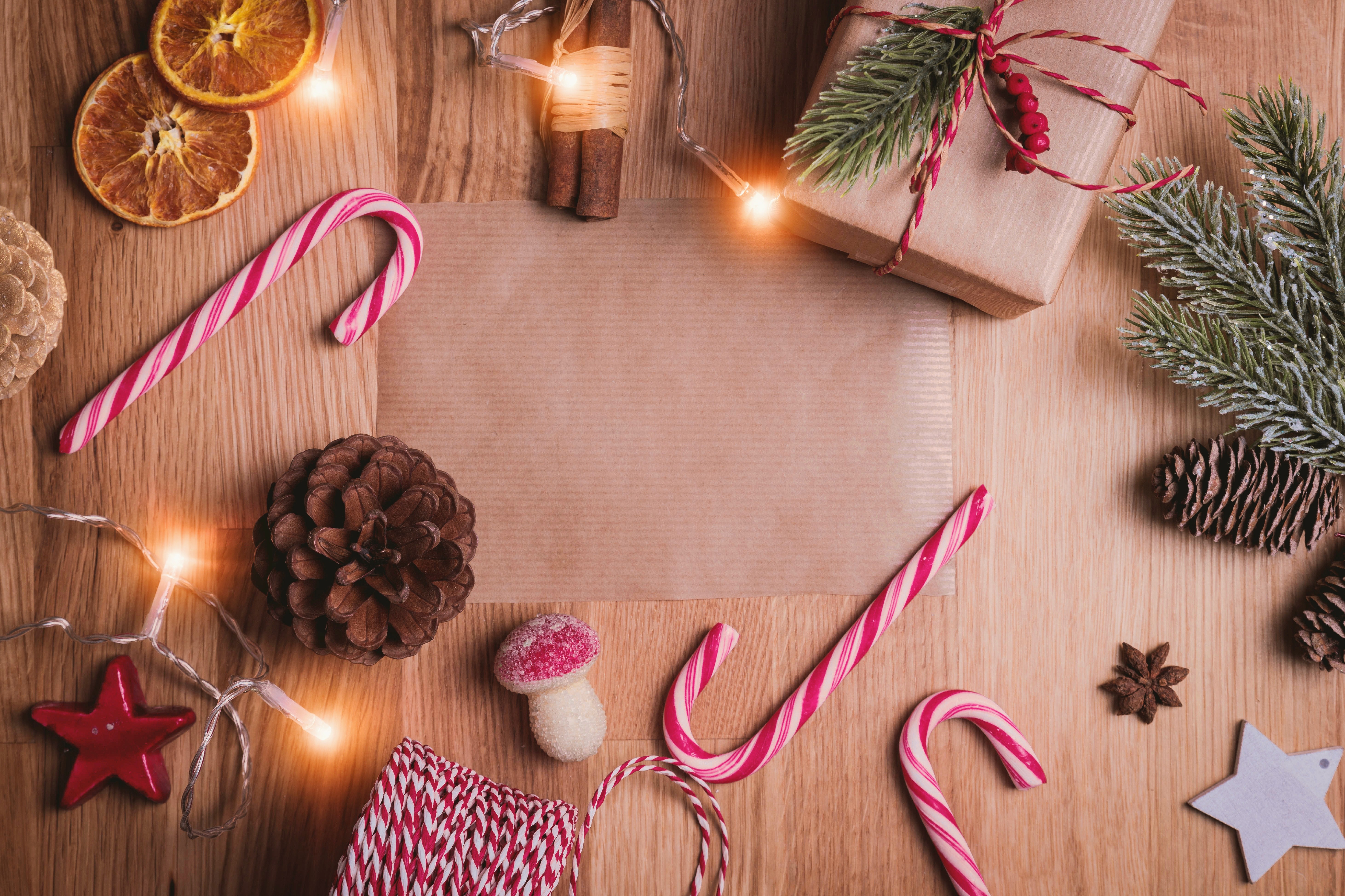 Christmas decorations around a blank piece of paper