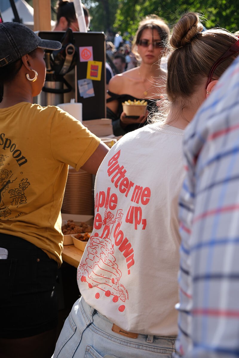 Two employees handing food to customers