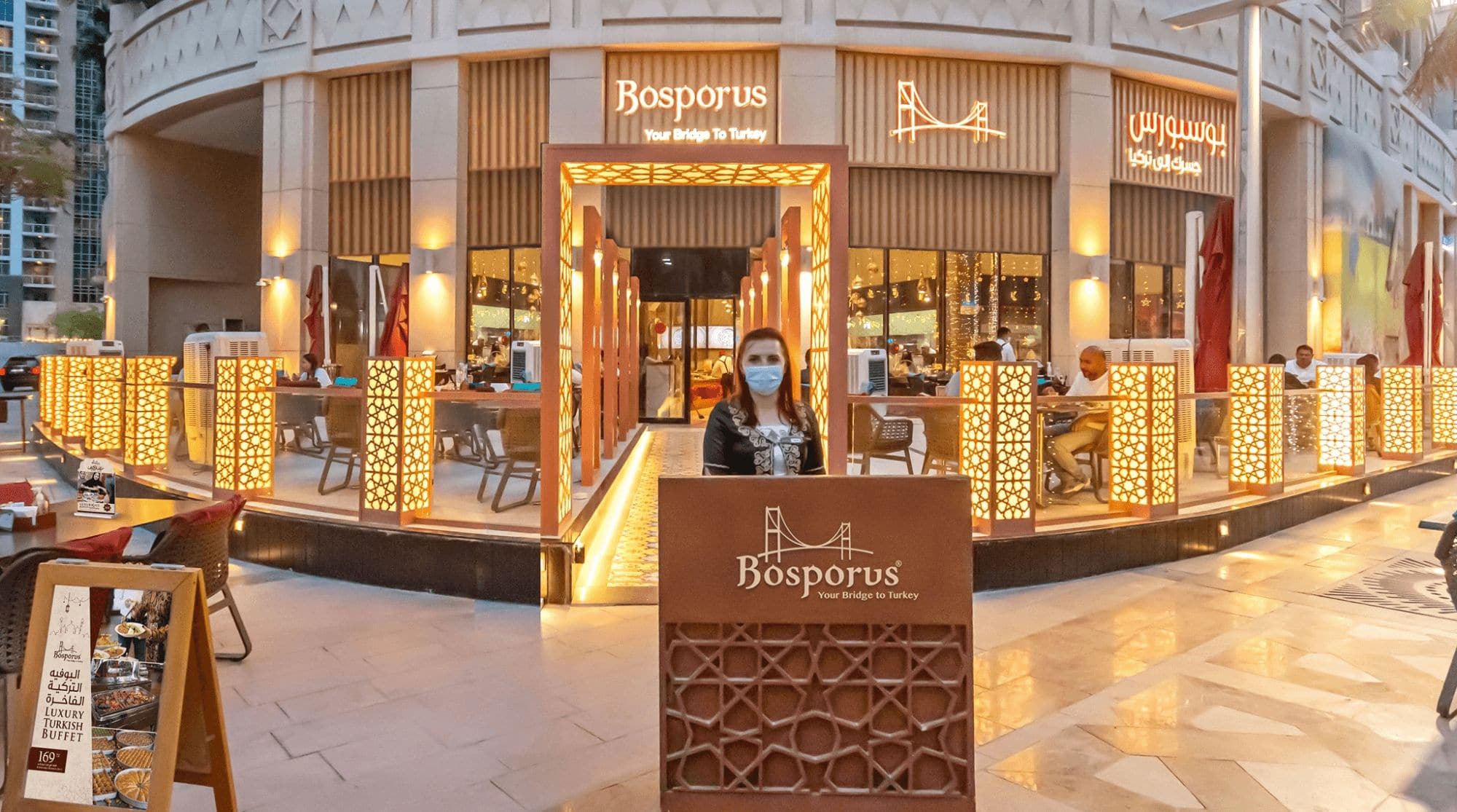 Bosporus in Dubai with a bright exterior design, outdoor seating, and glass interiors.