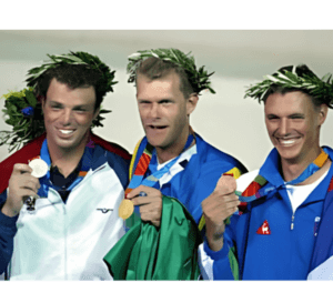 A man stading with Surfboard