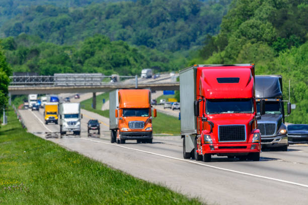  semi-truck on a highway with freight brokers in the background, representing the dynamics of broker transparency in the trucking industry.