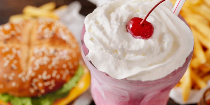 A combo meal consisting of a burger, milkshake, and fries