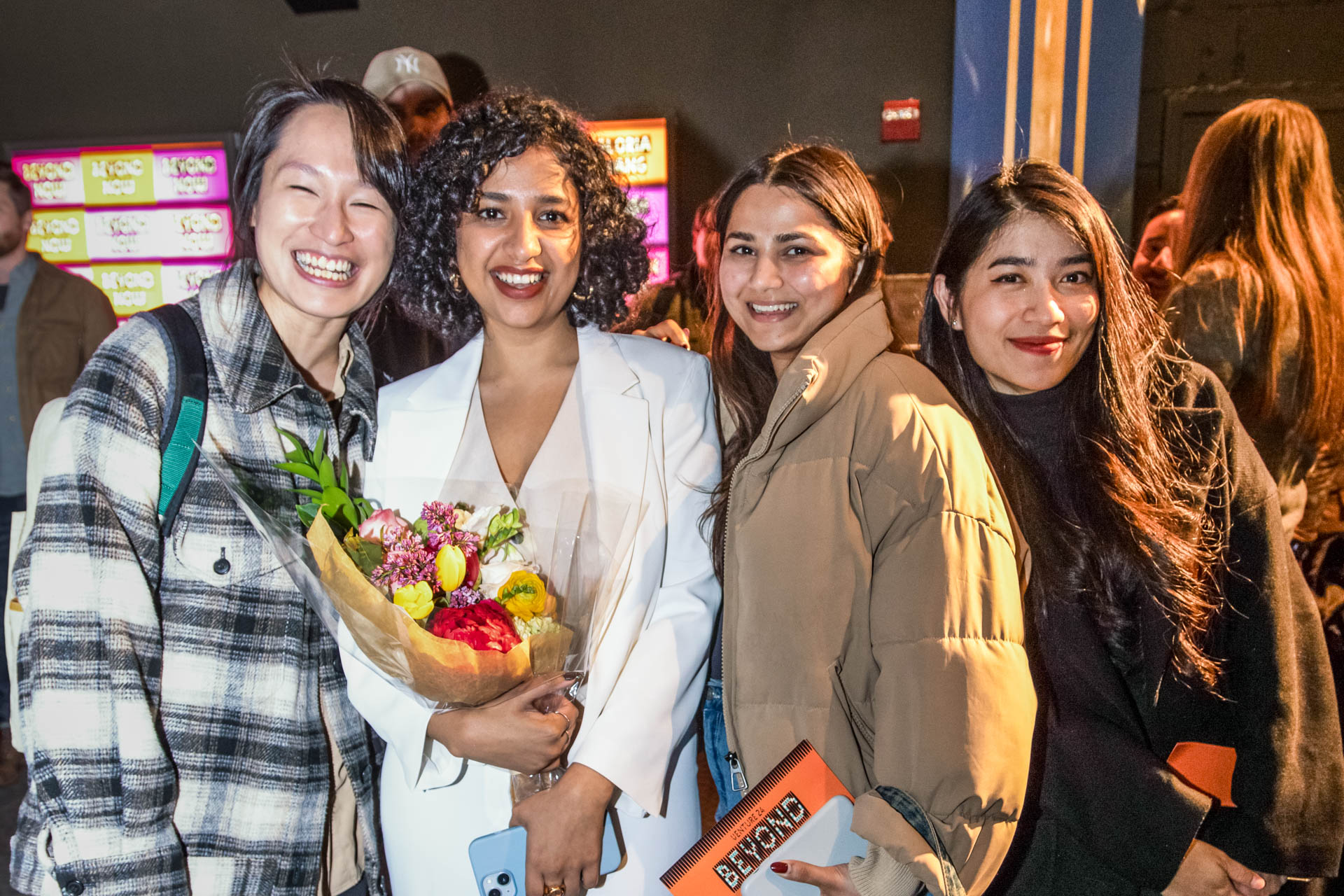a group of students smiling for the camera in the SVA Theatre lobby after the Venture Forum