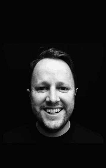 A professional headshot of a man