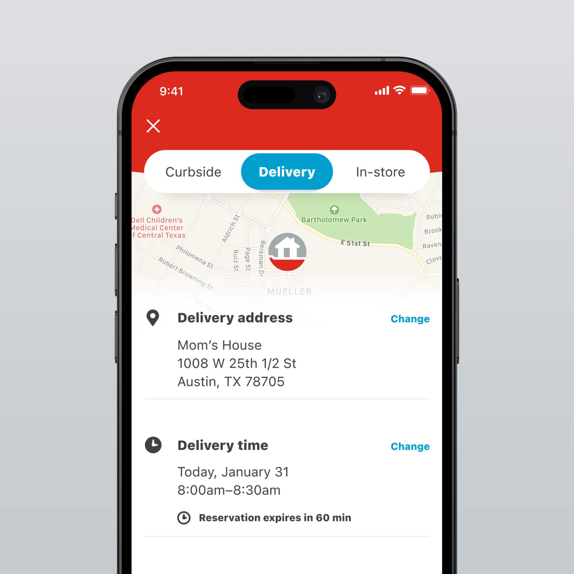 A smartphone showing the delivery options on the H-E-B app, with a map and details of the delivery address and time.