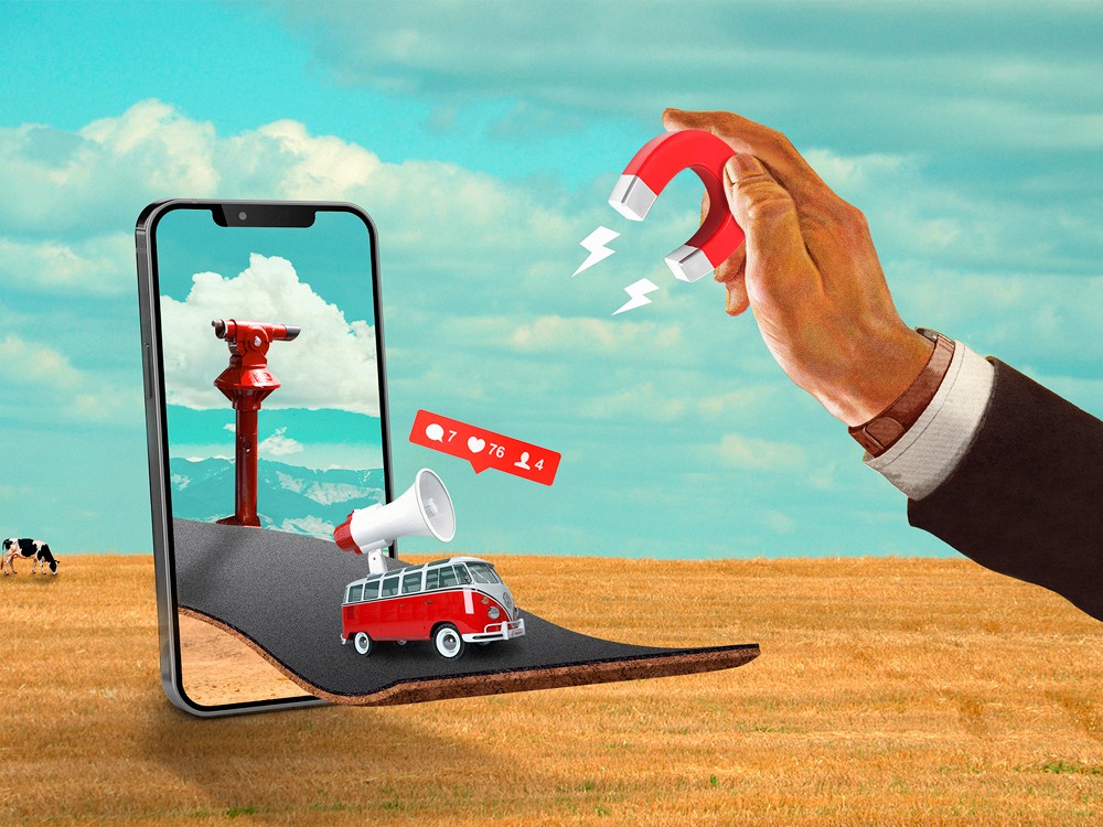 Móvil con carretera 3D, camioneta roja y mano sosteniendo imán sobre campo.