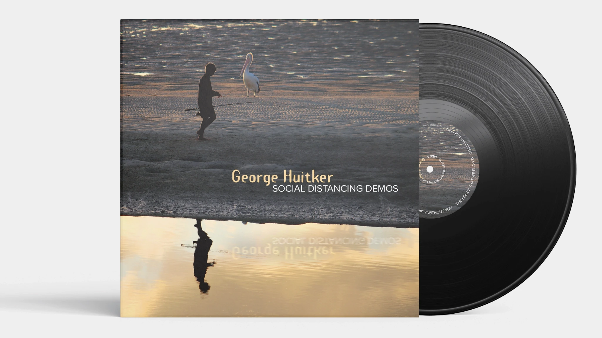 Vinyl record sliding out of a sleeve for Social Distancing Demos. The artwork features a silhouetted person walking past a pelican at sunset.