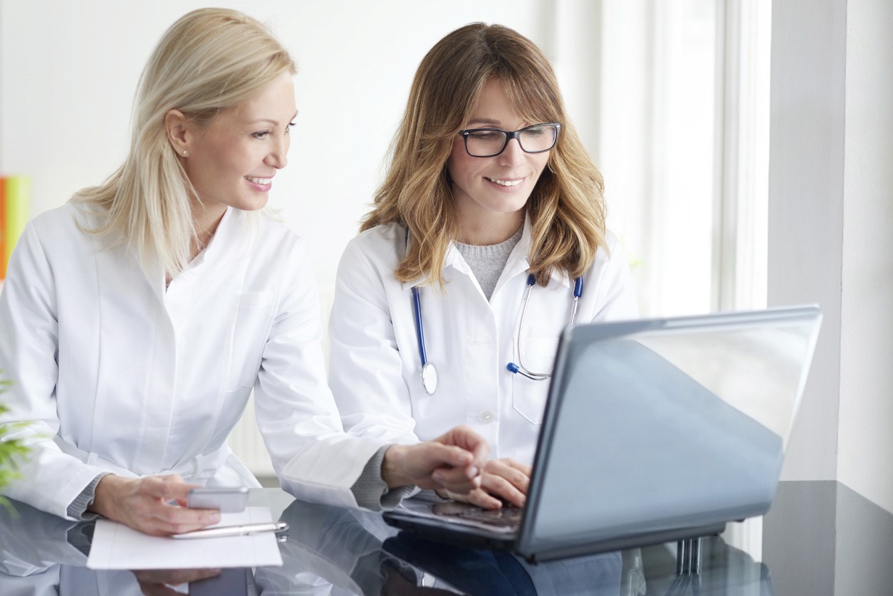 woman in white button up shirt and blue stethoscope