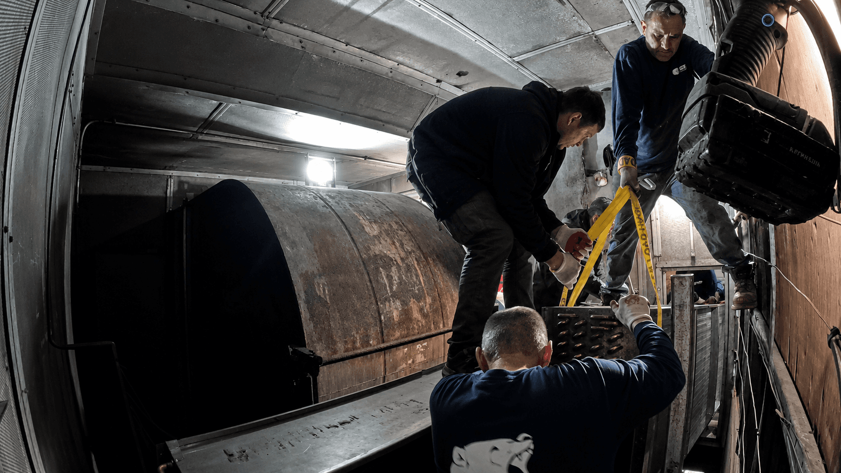 GRR Cooling Experts technicians installing a new chilled water coil section inside a hospital HVAC air handling unit in New York City.