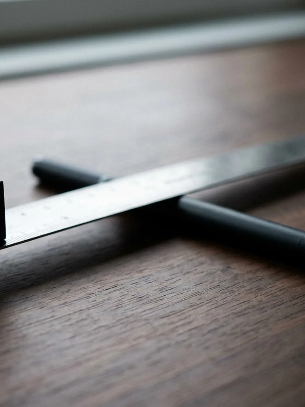 Ruler and pen on wood surface