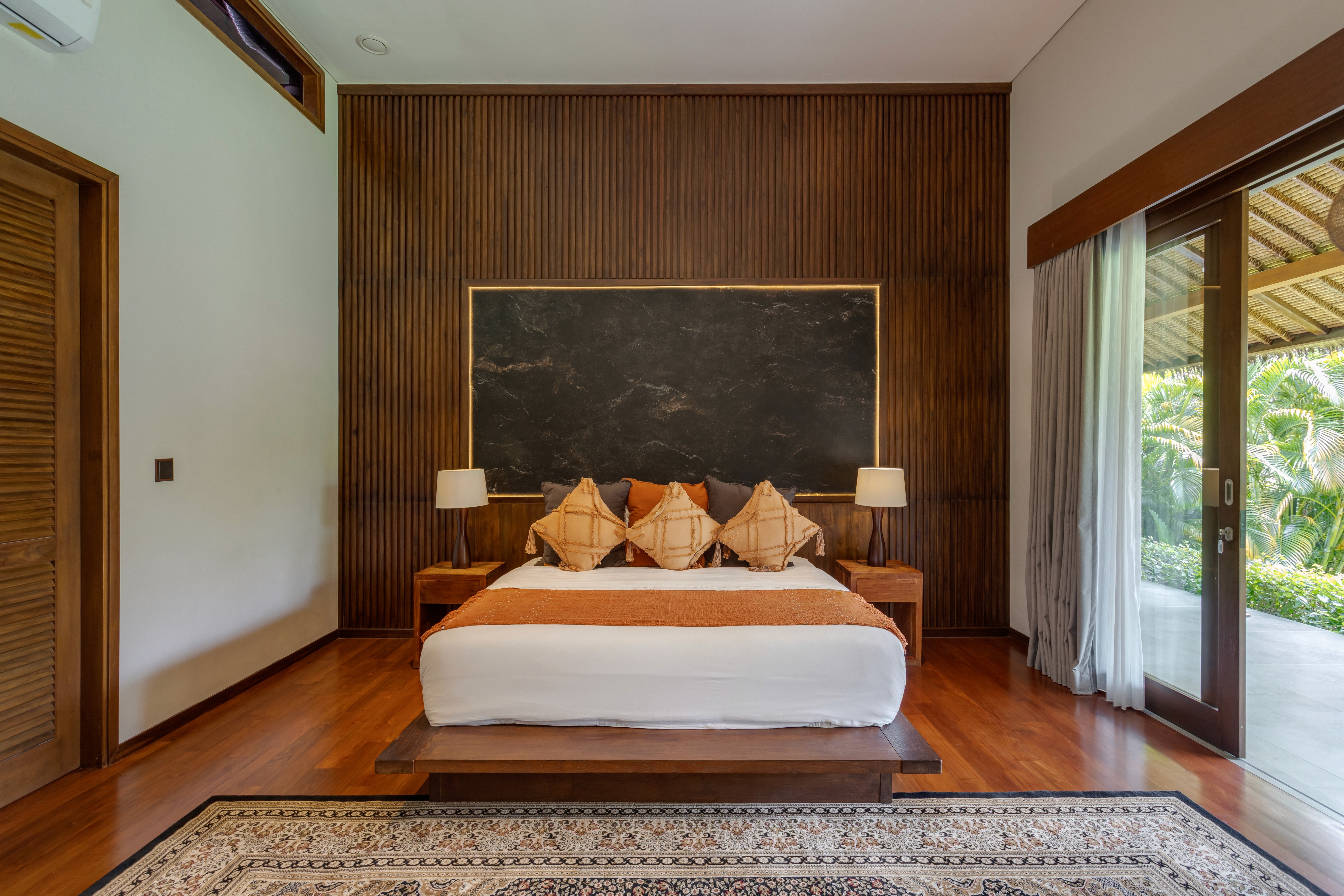 Bright bedroom with colorful bedspread and wall art