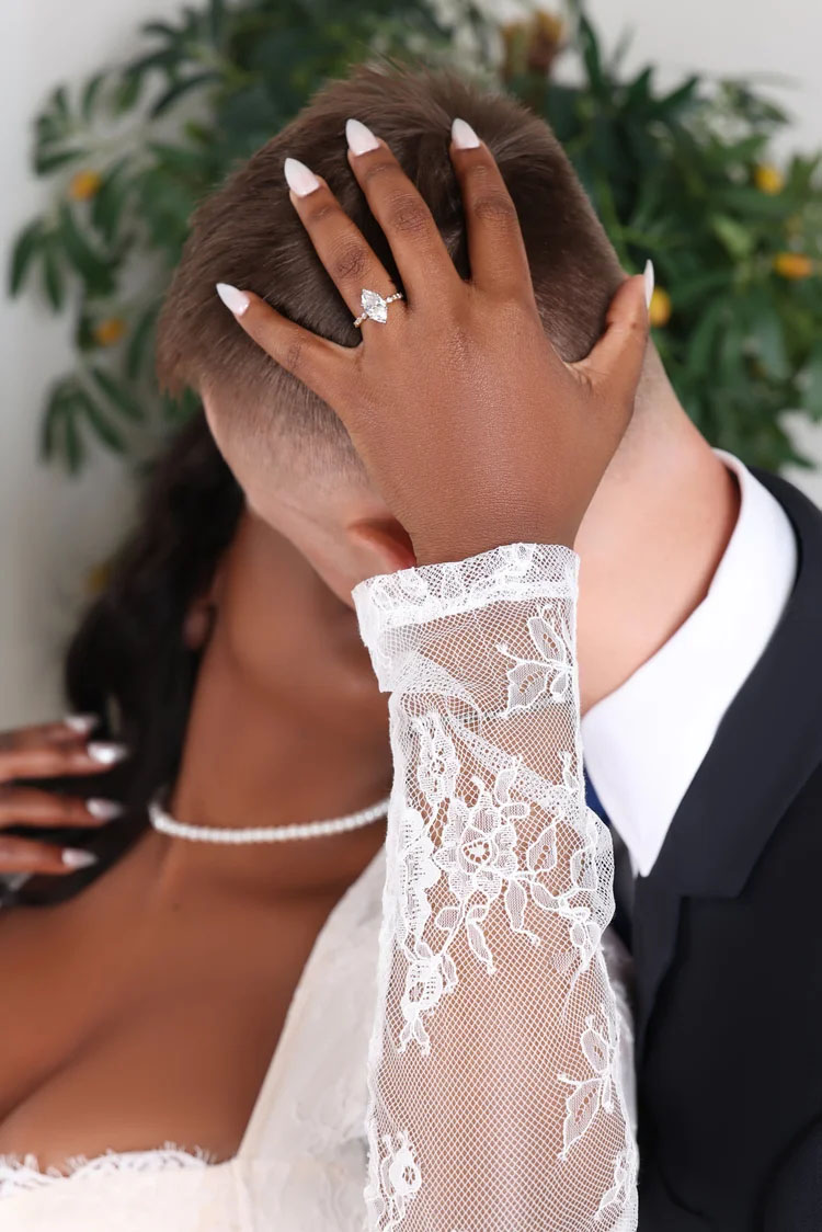 Close-up of a couple’s hands showing an engagement ring