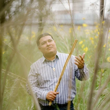 Lazaro Arvizu Jr. in a field of tall grass.