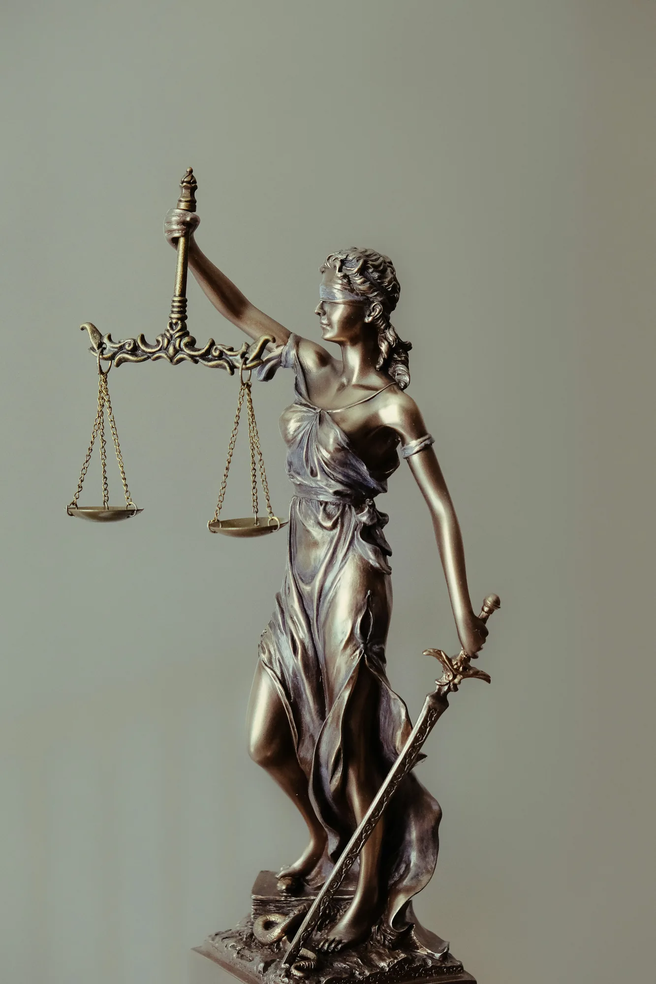 Bronze statue of Lady Justice holding the scales of justice