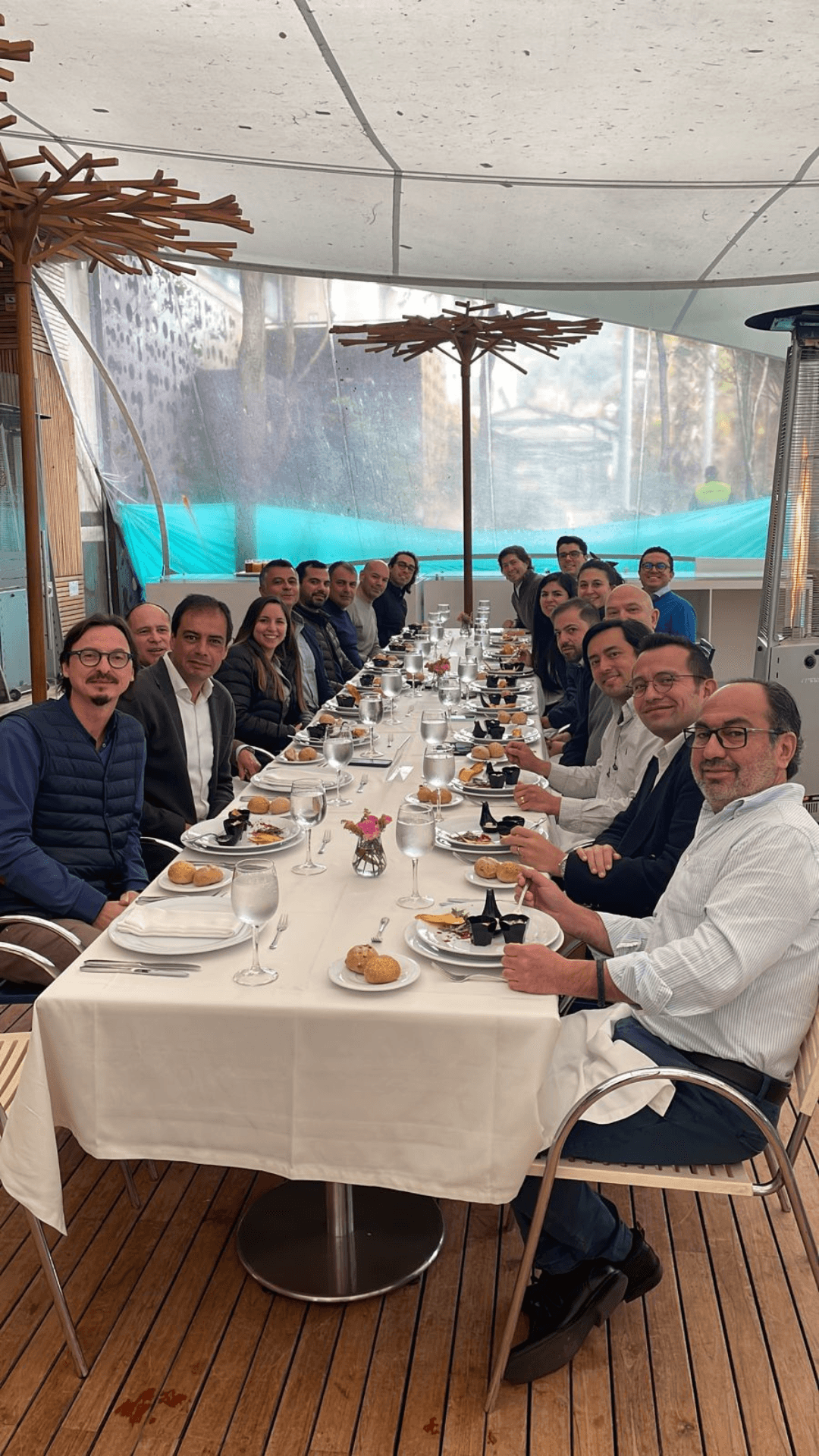 three people sitting in front of table laughing together