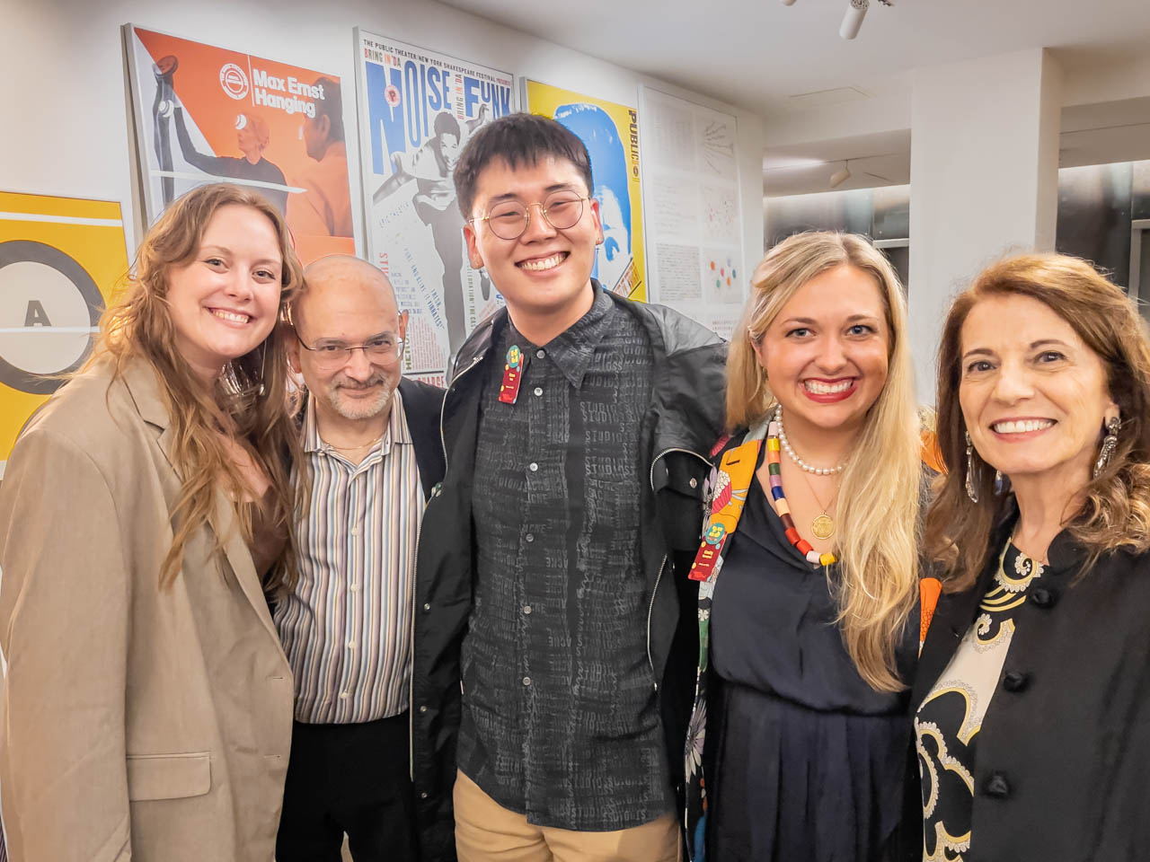 five people at a cocktail party looking at the camera